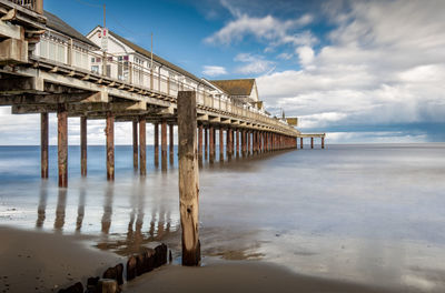 Pier over sea against sky