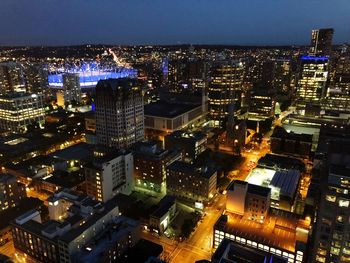 High angle view of illuminated city buildings at night