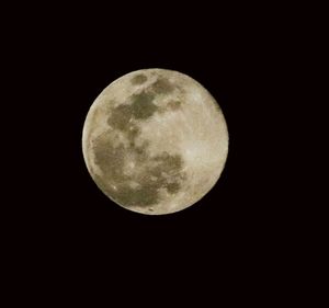 Low angle view of moon against dark sky