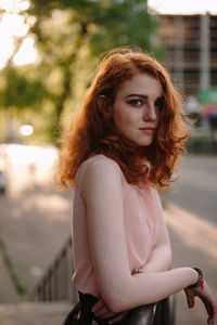 Portrait of young redheaded woman with freckles