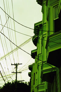 Low angle view of electricity pylon against sky