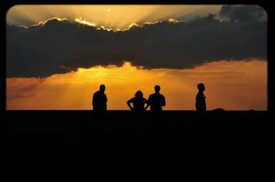 Silhouette people at sunset