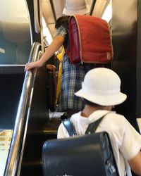 Rear view of man sitting in bus