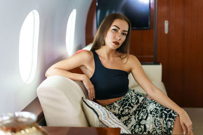 Travel and technology. flying first class. a pretty young business woman