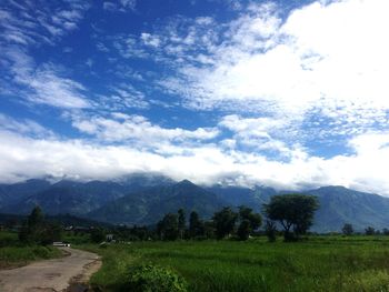 Scenic view of landscape against cloudy sky