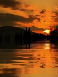 Scenic view of lake against orange sky