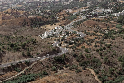 High angle view of road amidst trees and landscape