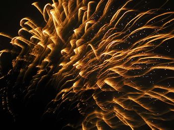 Low angle view of illuminated fireworks at night