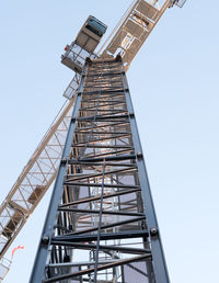 Low angle view of crane against clear sky