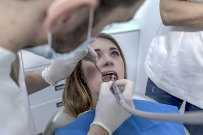 Midsection of doctor examining patient at clinic