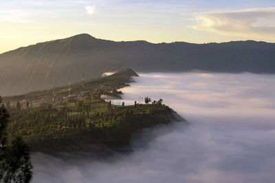 Low clouds at cemoro lawang village at sunrise at bromo tengger semeru national park,