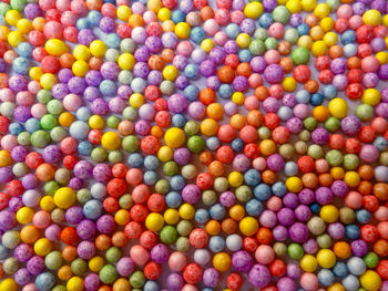 Directly above colorful polystyrene balls on table