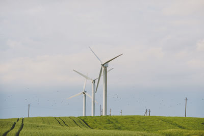 Windmill on field against sky