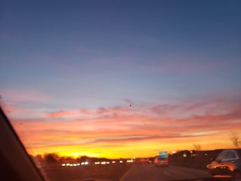 Silhouette city against sky during sunset