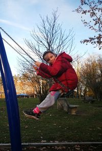 Low angle view of boy playing on slide