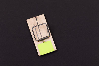 High angle view of information sign on table against black background