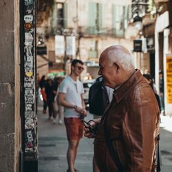 Men standing on street in city