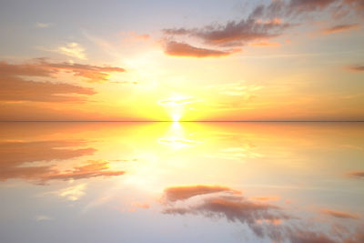 Digital composite image of clouds over sea during sunset