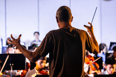 Rear view of people standing at music concert