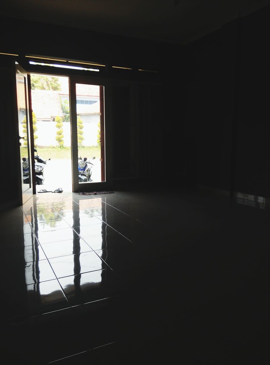 indoors, window, glass - material, transparent, home interior, dark, reflection, built structure, architecture, door, house, interior, empty, room, absence, flooring, illuminated, curtain, no people, sunlight