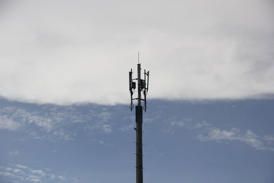 Low angle view of communications tower against sky