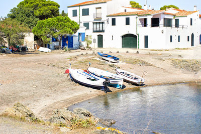 Bicycle moored on beach against buildings in city