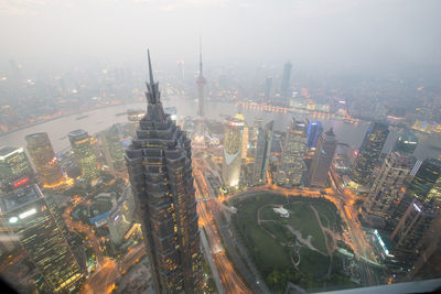 High angle view of oriental pearl tower by huangpu river in city