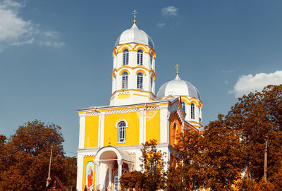 Orthodox church in autumn . monastery colored in yellow . silver dome and bell tower