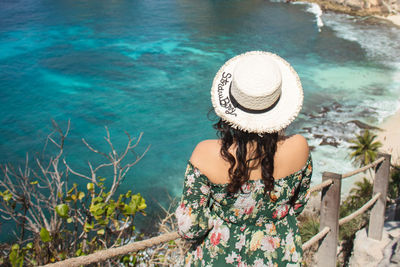 Young pretty asian woman feeling relax with mountain view at diamond beach in bali.