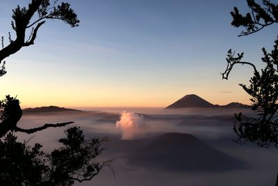 Scenic view of silhouette mountains against sky at sunset