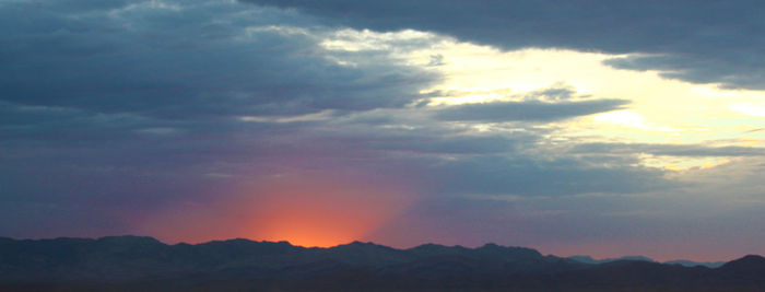 Scenic view of mountains against dramatic sky