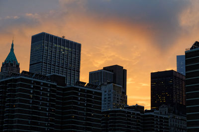 Low angle view of buildings against sky during sunset