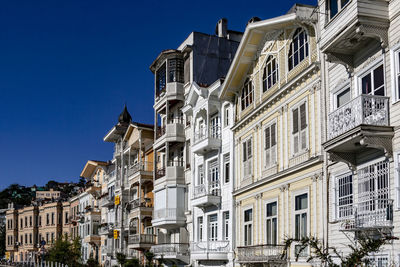 Low angle view of residential building against blue sky