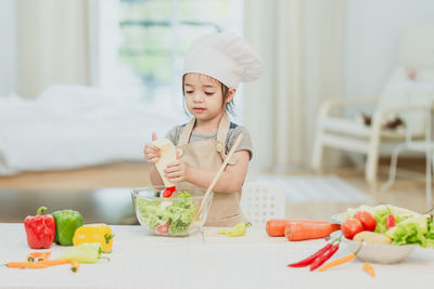 Cute girl preparing food on table