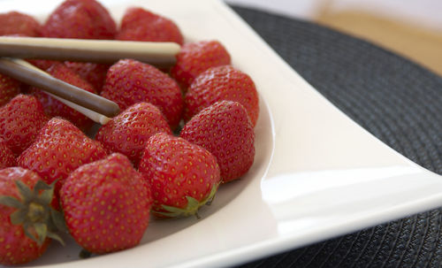 High angle view of strawberries in plate on table