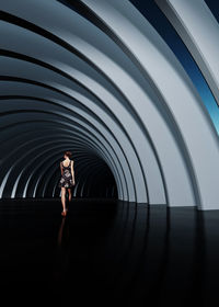Full length of woman running in tunnel