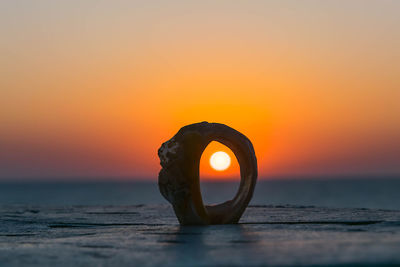 Mooring ring against sky during sunset
