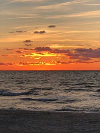 Scenic view of sea against romantic sky at sunset