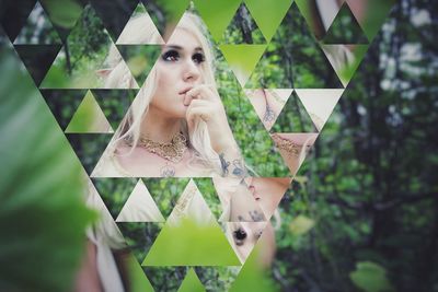 Portrait of young woman against plants
