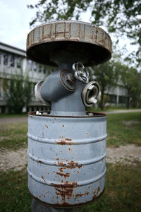 Close-up of rusty metal structure in field