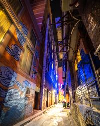 Low angle view of illuminated buildings in city at night