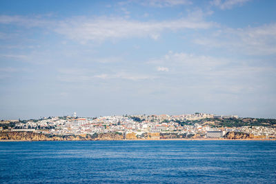 Townscape by sea against sky