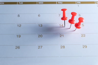 High angle view of thumbtack on calendar