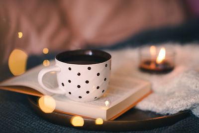 Close-up of illuminated tea light on table