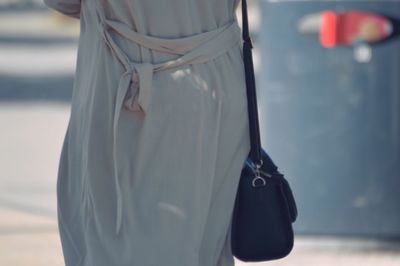 Midsection of woman standing on road