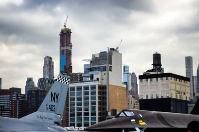 View of modern buildings against cloudy sky