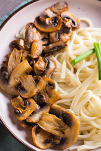 Close-up of fried mushrooms and noodles vertical view