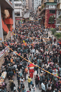 High angle view of people walking on street in city