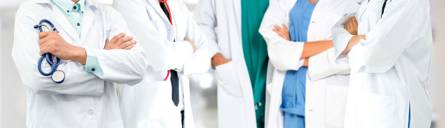 Midsection of doctors standing in hospital