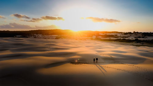 Scenic view of beach against sky during sunset